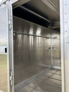 24' x 8' Stock Combo Trailer. Tandem 8,000 lbs Torsion Axles. ST215/75 R17.5(M) 16 Ply Tires on 17.5 X 6.75 Steel Rims. One Moveable Divide Gate. 36" Roadside Door.