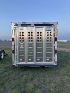 24' x 7' Lariat Stock Combo Trailer. Tandem 7,000 lbs Torsion Axles. ST235/85 R16(M) 14 Ply Tires on 16 X 6 Steel Rims Locking Tack Room with Four Removable Saddle Racks, Bridle Hooks, and Blanket Bar. One Fixed Divide Gate. 36" Roadside Door. Six Inside Tie Loops. Four Outside Tie Loops Roadside.